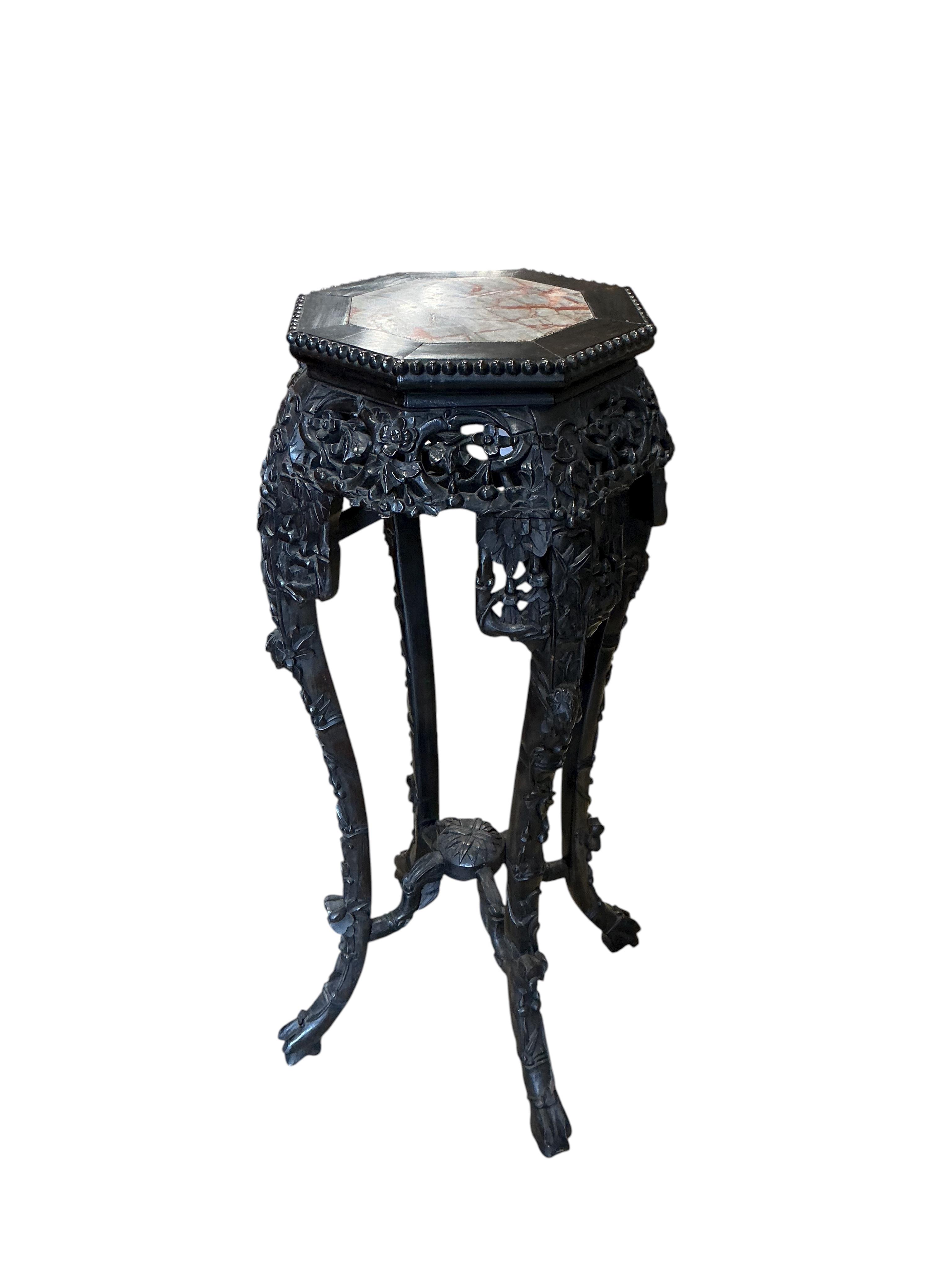 A Chinese marble topped octagonal vase stand, width 38cm, height 90cm